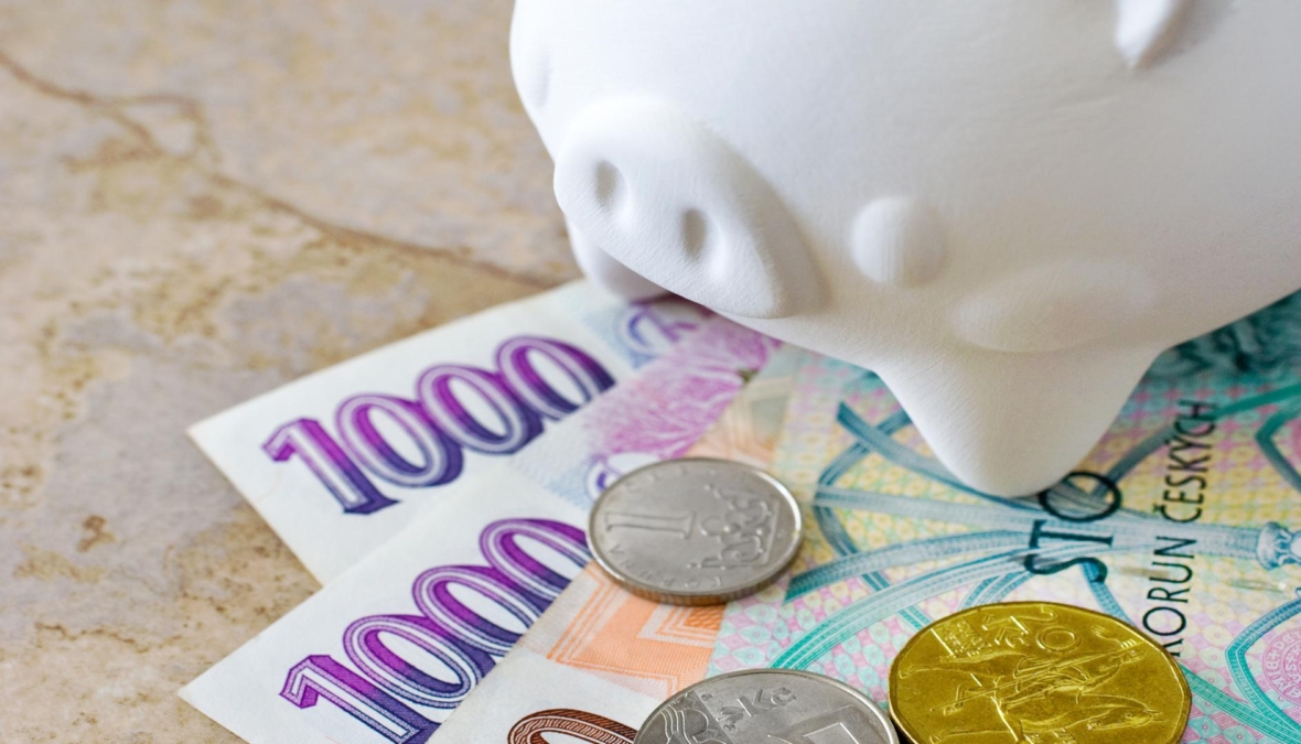 Czech crown banknotes and coins with piggy bank