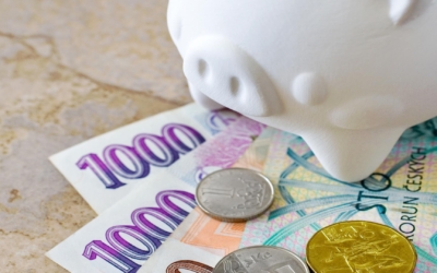 Czech crown banknotes and coins with piggy bank